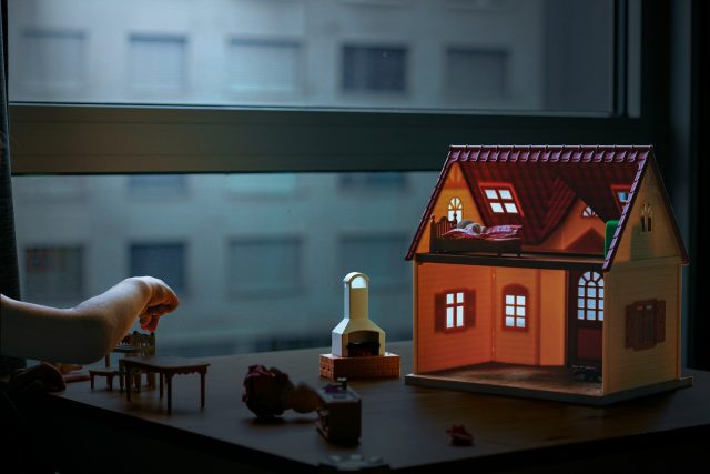 Photo by Jeewantha Dilshan brown wooden house miniature on brown wooden table