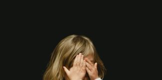 girl covering her face with both hands