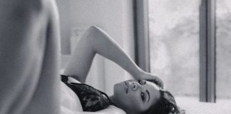 topless woman lying on bed