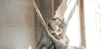 woman and angel kissing statue