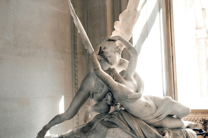 Photo by Sara Darcaj woman and angel kissing statue