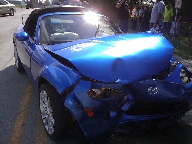 a-blue-car-with-a-damaged-front-end-ai-generated A blue car with a damaged front end AI-generated content may be incorrect.