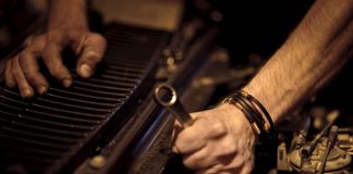 grayscale photo of person playing piano
