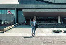 Fitness, Finance, and Focus: The Discipline Triangle for High-Performing Professionals man walking while holding black coat