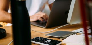 person using silver MacBook