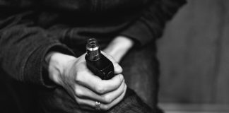 a person holding a bottle of alcohol in their hand