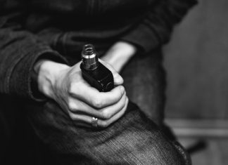 a person holding a bottle of alcohol in their hand