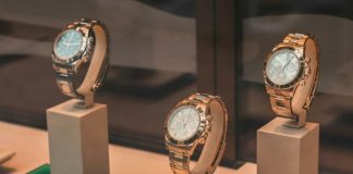 three round silver-colored chronograph watches on white mounts