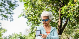 Senior runner using a fitness tracker