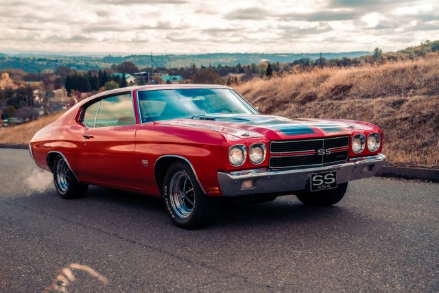 Photo by Meritt Thomas red chevrolet camaro on road during daytime