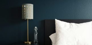 gray table lamp beside white bed pillow