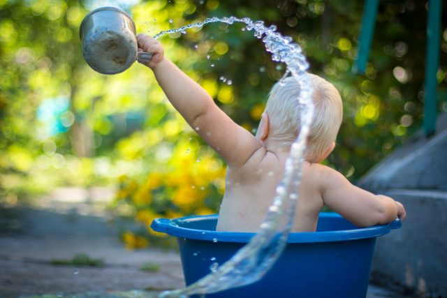 Photo by Lubomirkin child lifting water dipper