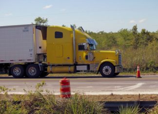 The Benefits of Hiring a Nearby Truck Accident Attorney for Your Case a yellow semi truck driving down a road