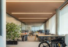 Reviving the Past: How To Transform a Vintage Building Into a Modern Office Space an office with a bike parked in the middle of the room