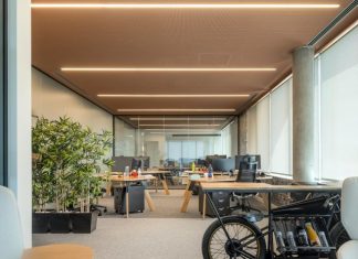 Reviving the Past: How To Transform a Vintage Building Into a Modern Office Space an office with a bike parked in the middle of the room