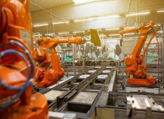 How Heavy Industry is Going to be Affected by Trump Tariffs a factory filled with lots of orange machines
