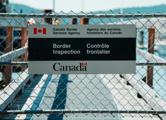 How To Navigate Canadian Immigration Law After Losing Your Job blue and white metal fence