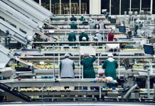 How Employee Ownership Impacts Local Economies a group of people in a factory
