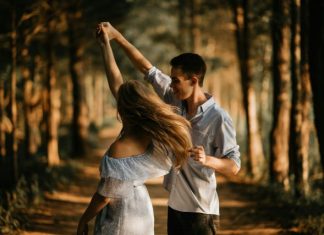 How Media Shapes Our Views on Romance man and woman dancing at center of trees