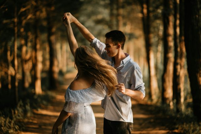 Photo by Scott Broome man and woman dancing at center of trees