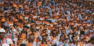 group of people wearing orange caps
