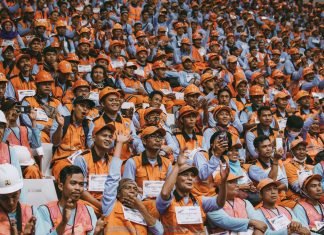 5 Things Most People Get Wrong About Workers’ Compensation Cases group of people wearing orange caps