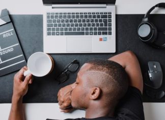 From Burnout to Breakthrough: How CE Courses Can Reignite Your Passion for the Profession a man sitting at a desk with a laptop and headphones