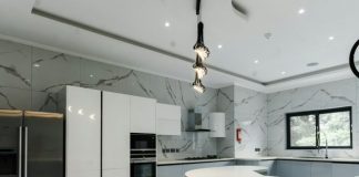 a modern kitchen with marble counter tops and stainless steel appliances