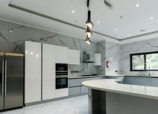 The Quickest Way to Achieve a Clean Kitchen a modern kitchen with marble counter tops and stainless steel appliances
