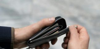 a person holding a wallet in their hand