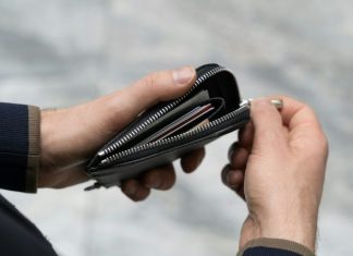 Why It’s Time to Get Serious About Protecting Your Wallet a person holding a wallet in their hand