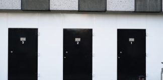 black door on white concrete wall