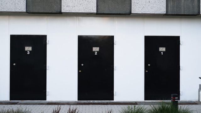 Photo by Sebastian Herrmann black door on white concrete wall