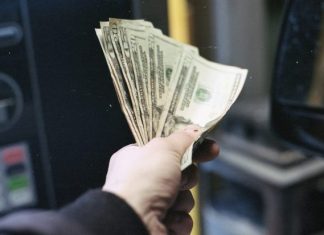 How to Qualify for an Instant Cash Advance in California (Even With Bad Credit) person holding fan of us dollar bill