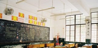 a classroom filled with desks and a chalkboard