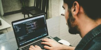 man programming using laptop