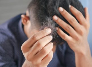 QR678’s Groundbreaking Hair Growth Solution: The Future of Innovative Hair Loss Regime a man is combing his hair with his hands