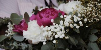 a bouquet of white and pink flowers and greenery