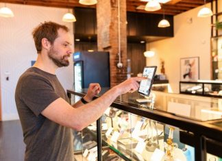 Mapping Touchpoints With Customer Journey Consulting: From Awareness To Advocacy a man standing in front of a display case holding a tablet