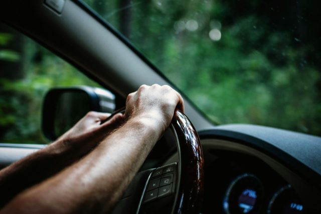 Photo by Erik Witsoe person holding car steering wheel