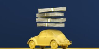 a yellow car with stacks of money on top of it