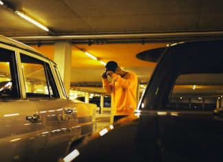 Fastest Way to Handle a Car Lockout in Chicago man holding cap standing between car on parking lot