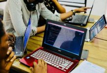 Mastering Positive and Negative Testing for Better QA person using black and red Acer laptop computer on table