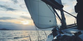 white sailing boat on body of water