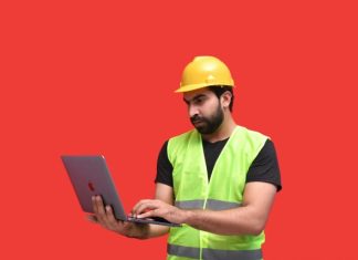 A Strategic Guide to Choosing the Right MS4 Inspection Software a man in a yellow hard hat holding a tablet