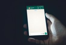 How to Recover WhatsApp Chat from iPhone (Step-by-Step Guide) person holding smartphone