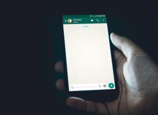 How to Recover WhatsApp Chat from iPhone (Step-by-Step Guide) person holding smartphone