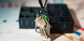 A house shaped keychain hanging from a key chain