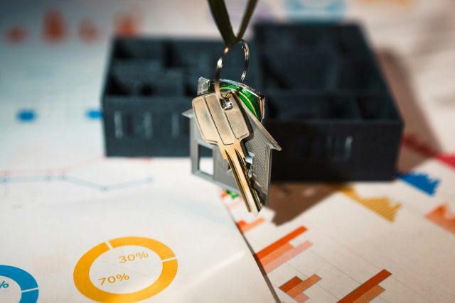 Photo by Jakub Żerdzicki A house shaped keychain hanging from a key chain