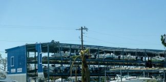 a boat yard with boats and a large building